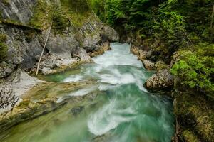 fast flowing torrent between rocky walls in hinterstoder austria photo