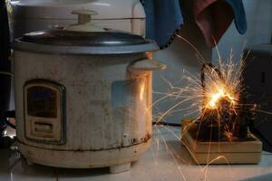 Electric short, plug, rice cooker Therefore causing sparks Dangerous concepts from the use of old electrical appliances And without quality Therefore is dangerous to life and property photo