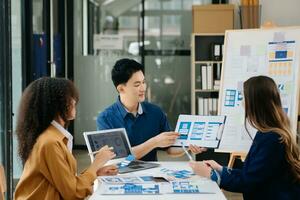 UX developer and ui designer brainstorming about mobile app interface wireframe design with customer breif and color code photo
