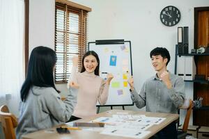 Close up view of UI developer team brainstorming on their project with laptop, smartphone and digital tablet. photo