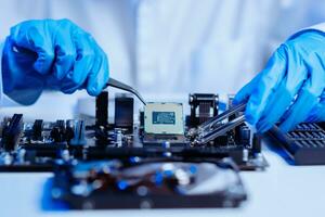 The technician is putting the CPU on the socket of the computer motherboard. electronic engineering electronic repair, electronics photo