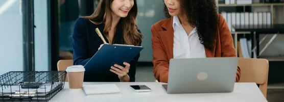 Business colleague business presents and explains and using laptop and tablet. Teamwork, financial marketing team, photo