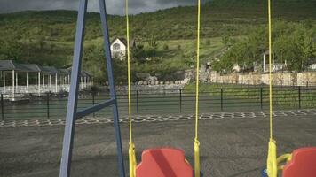 a swing set in front of a lake video
