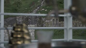 a view of a waterfall from inside a window video