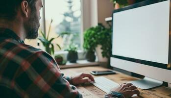 ai generado terminado hombro Disparo de un joven hombre utilizando computadora en frente de un blanco blanco computadora pantalla en hogar foto