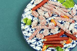 Tasty salami on a plate photo