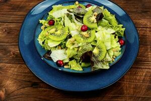 Healthy diet, salad of kiwi and herbs. photo