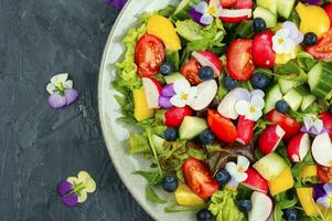 Spring salad with edible flowers. photo
