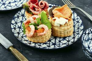 Tartlets with seafood and bacon, tasty snack. photo