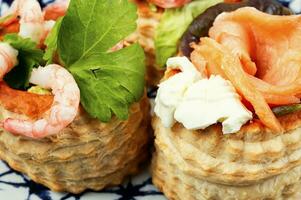 Tartlets with seafood and bacon, tasty snack. photo