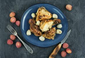 Roasted chicken pieces with lychee. photo