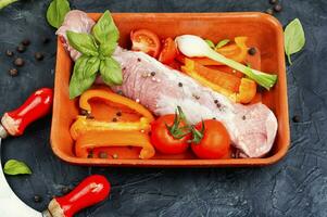 Raw uncooked meat tenderloin in a baking dish. photo