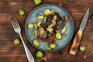 Fried ostrich steak with kiwi sauce photo
