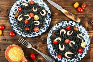 Vegan black spaghetti with shrimp. photo