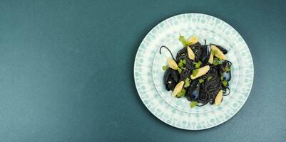 Black pasta with mussels and corn. photo