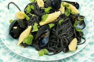 Black spaghetti pasta with mussels. photo