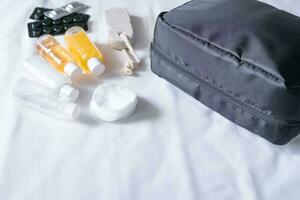 Travel cosmetics kit on bed , top view photo