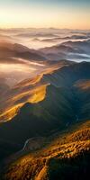 AI generated Aerial view of mountains in low clouds at sunrise in autumn. Top drone view of hills with red and orange trees in fog, colorful sky in fall. Slovenia. Nature. Mountain valley. photo