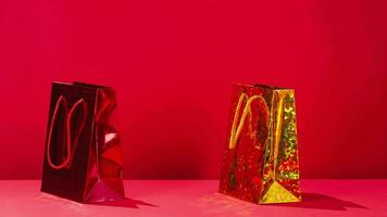 Rabatte, Verkauf, Einkaufen, Geschenke Konzept. rot und Gelb Geschenk Taschen ziehen um auf ein rot Hintergrund Kopieren Raum halt Bewegung Animation 4k Video
