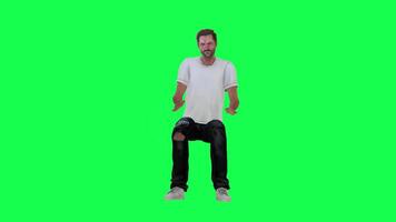 A thin criminal man in a green screen with a white t-shirt and black pants, torn video