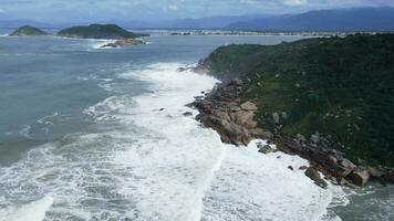 Big stormy waves in ocean. Aerial view of coastline with mountain and rocks video