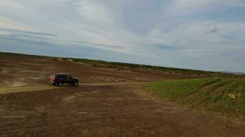 Auto im Wüste Straße Antenne Aussicht Schneiden durch wild Terrain Auto Wüste Symbol Geschwindigkeit Abenteuer. Auto Wüste Reise durch extrem Landschaften erkunden unberührt unfruchtbar Landschaften oben Sicht. video