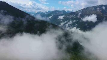 Beautiful alpine green mountains and cloud-filled valley video