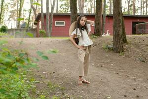 preadolescente niña posando con confianza en país inmuebles en pino bosque en verano foto