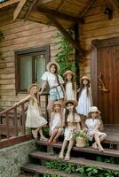 Tween girls posing on threshold of wooden rural house on summer day photo