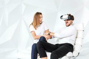 Couple having fun playing with virtual reality photo