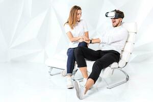 Couple having fun playing with virtual reality photo