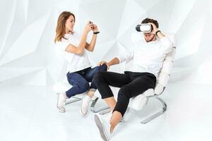 Couple having fun playing with virtual reality photo