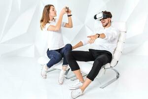 Couple having fun playing with virtual reality photo