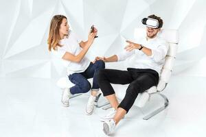Couple having fun playing with virtual reality photo