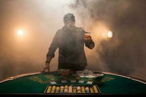 Male gambler playing poker, smoke dark color intensity. photo