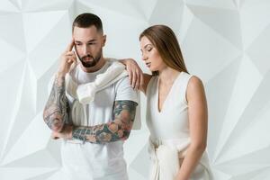 Young couple in casual clothing on white background photo