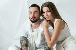 Fashionable couple posing at studio. photo