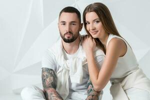 Fashionable couple posing at studio. photo