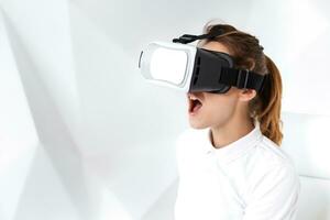 Technology, virtual reality, entertainment and people concept - happy young woman with virtual reality headset sits on a white armchair photo