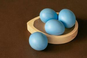 Easter blue eggs on a brown background. photo