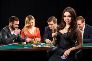 Young people playing poker at the table. Casino photo