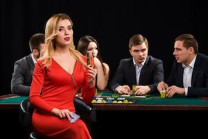 Young people playing poker at the table. Casino photo