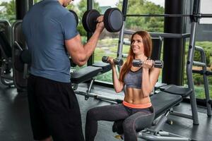 happy cutie athletic girl , execute exercise with dumb-bells photo