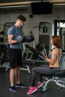 happy cutie athletic girl , execute exercise with dumb-bells photo