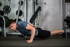 sports guy push-ups in the gym photo