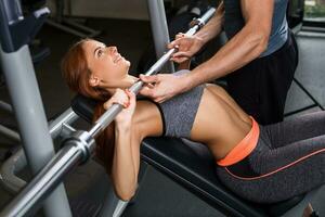 happy cutie athletic girl , execute exercise in sport-hall photo