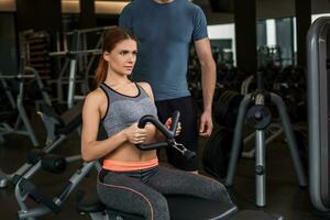 happy cutie athletic girl , execute exercise in sport-hall photo