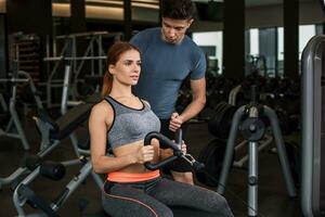 happy cutie athletic girl , execute exercise in sport-hall photo