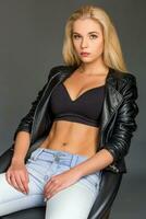 blond woman in a jacket is sitting on chair photo