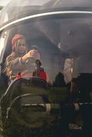 Focused preteen girl imitating helicopter control on co-pilot seat photo
